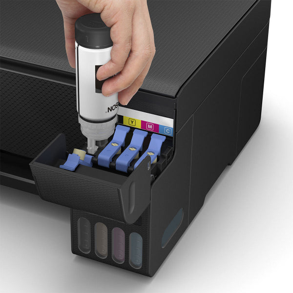 Hand inserting an ink cartridge into l3210 printer with visible ink colors.