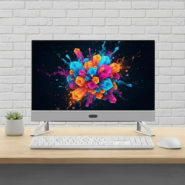 Four modern computer monitors displaying tech website, sales charts, colorful gradient, and sunset landscape