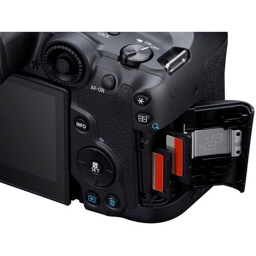 Canon EOS R7 body with open battery compartment on a white background