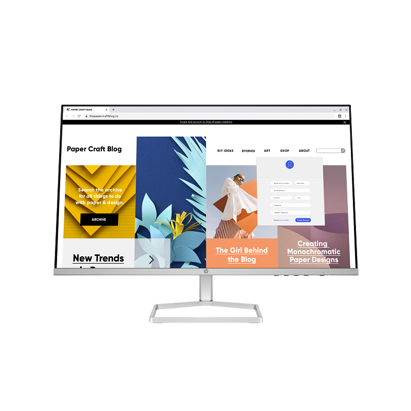 Computer monitor displaying a website with colorful design elements on a white background