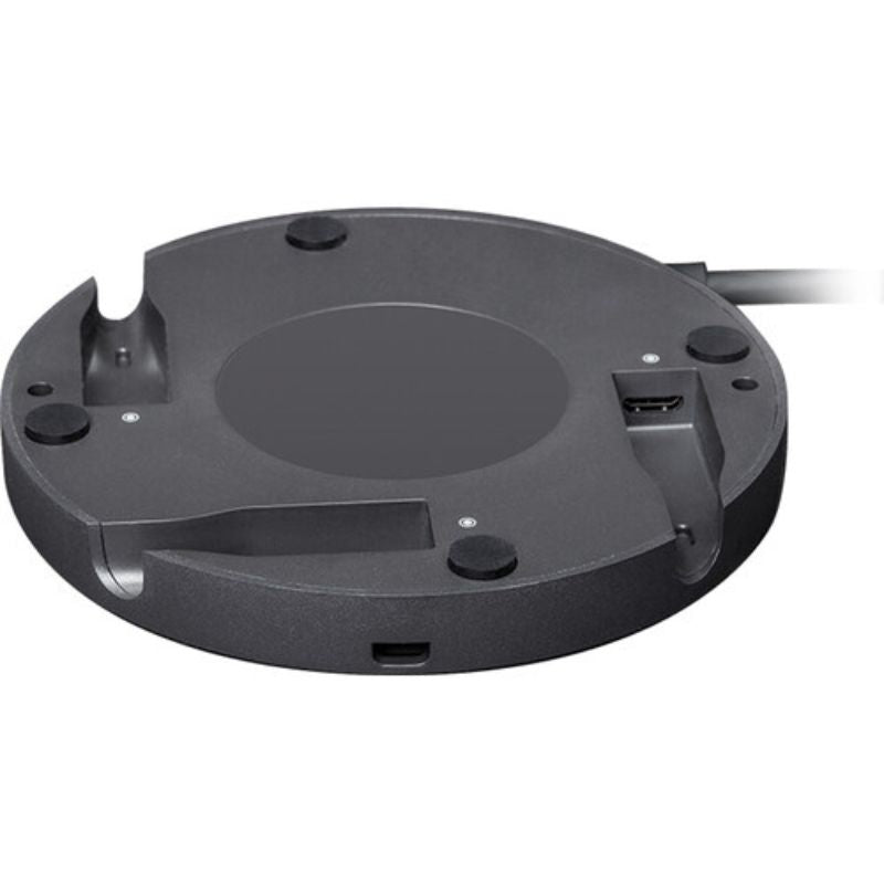 Black circular electronic device on a white background