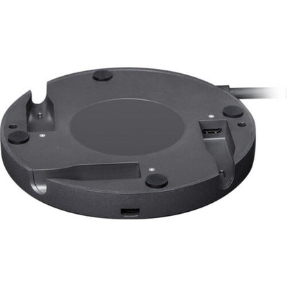 Black circular electronic device on a white background
