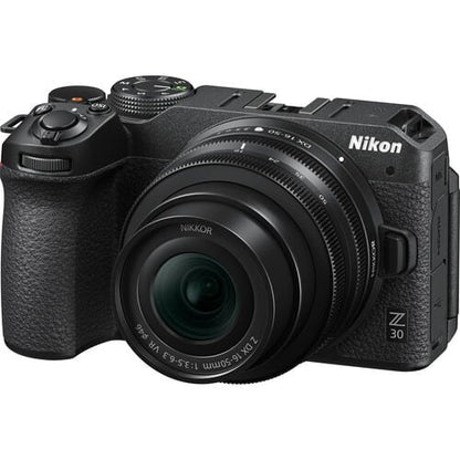Black Nikon camera with Nikkor lens on a white background
