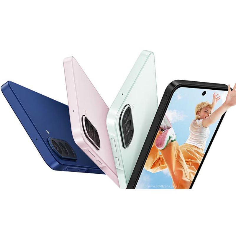 Three smartphones in different colors displayed with a phone screen showing a person playing with a dog.