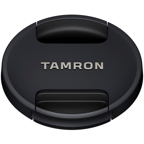Black camera lens cap with 'Tamron' branding on a white background